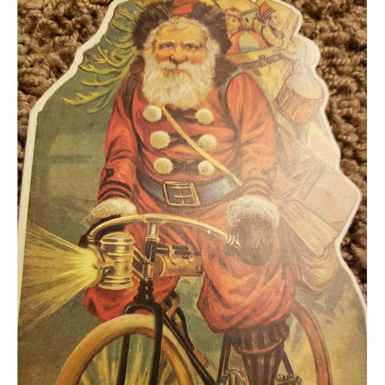 Vintage 1985 Merrimack Santa Bicycle Christmas Die Cut Hanging Card Ornament